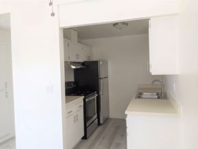 Santa Paula apartment for rent - White kitchen cabinets and electric range in apartment unit at the Steckel Apartments in Santa Paula, California.