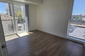 San Diego apartment for rent - A room with a sliding glass door leading to a balcony.