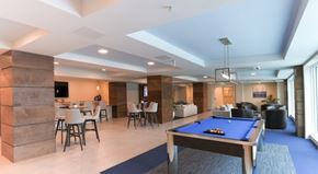 Clearwater apartment for rent - A well-lit room with a pool table and a bar area.