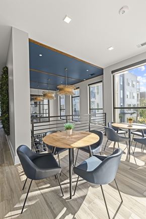 Wilmington apartment for rent - A modern dining area with a round wooden table surrounded by grey chairs.