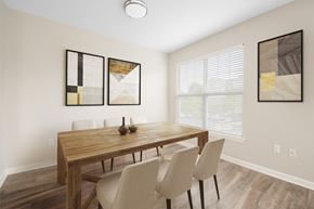 Canton apartment for rent - a dining room with a wooden table and white chairs