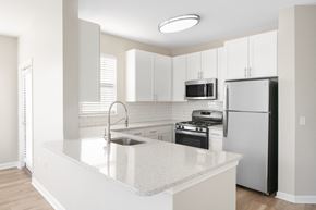Canton apartment for rent - a kitchen with white cabinets and a white counter top