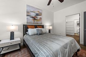 Raleigh apartment for rent - a bedroom with a bed and a ceiling fan