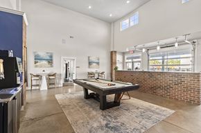 Leland apartment for rent - A room with a pool table and a brick wall.