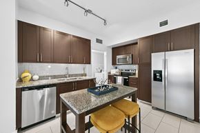 Pembroke Pines apartment for rent - A kitchen with brown cabinets and a granite countertop.