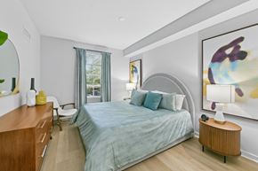 Pembroke Pines apartment for rent - A bedroom with a bed, nightstand, and a painting on the wall.