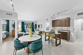 Pembroke Pines apartment for rent - A modern dining room with a round table and blue chairs.