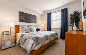 Pembroke Pines apartment for rent - A bedroom with a bed, nightstand, and a painting on the wall.
