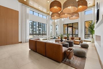 Charlotte apartment for rent - A modern living room with a large sectional sofa and a wooden ceiling.
