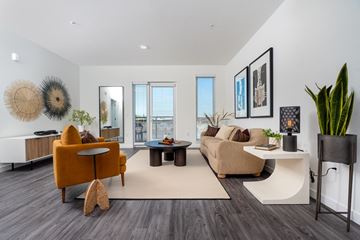 Lynnwood apartment for rent - A living room with a yellow chair and a white table.