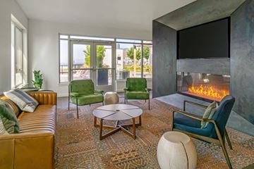 Seattle apartment for rent - a living room with a fireplace and a couch and chairs