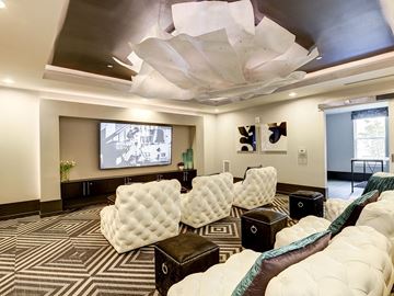 Rockville apartment for rent - a large living room with a large couch and a projector screen