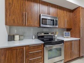 Fort Lauderdale apartment for rent - a kitchen with a stove microwave and cabinets