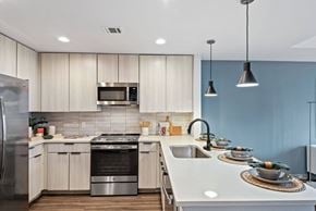 Charlotte apartment for rent - a kitchen with white cabinets and blue walls