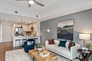 Charlotte apartment for rent - a living room with a couch and a coffee table in front of a kitchen