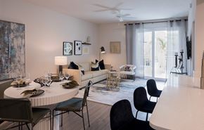 Boca Raton apartment for rent - A modern dining room with a round table set for six.