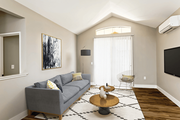 San Jose apartment for rent - A living room with a grey couch and a painting on the wall.