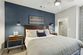 Annapolis apartment for rent - a bedroom with a large bed and a blue accent wall