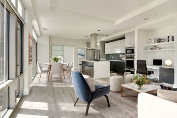 North Bethesda apartment for rent - A modern living room with a blue chair in the foreground.
