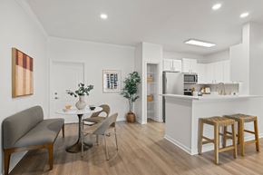Orlando apartment for rent - A modern kitchen with a dining table and chairs.