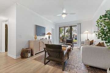 Orlando apartment for rent - A living room with a brown chair and a grey couch.