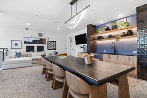 Atlanta apartment for rent - A modern dining room with a long wooden table and chairs.