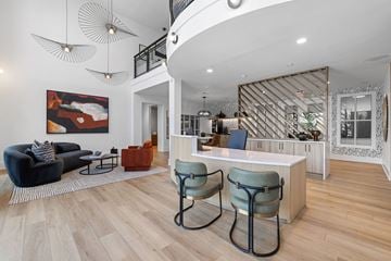 Atlanta apartment for rent - A living room with a black sofa and a wooden floor.