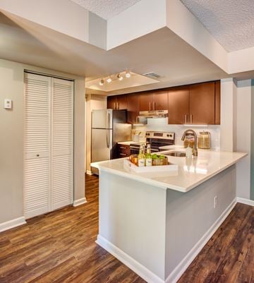 Boca Raton apartment for rent - A kitchen with a white counter top and wooden floors.