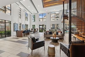 Atlanta apartment for rent - A spacious lobby with a variety of seating options and a staircase.