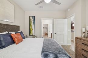 Atlanta apartment for rent - A bedroom with a large bed and a painting on the wall.