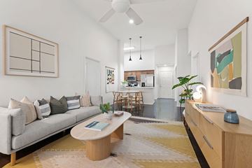 Tampa apartment for rent - A living room with a grey couch, a coffee table, and a painting on the wall.