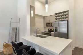 Richardson apartment for rent - a kitchen with a large white counter top and a stainless steel refrigerator