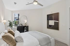 Atlanta apartment for rent - A bedroom with a large bed and a painting on the wall.