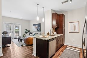Atlanta apartment for rent - A kitchen with a black counter top and brown cabinets.