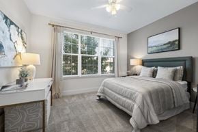 Atlanta apartment for rent - A bedroom with a large bed and a window with blinds.
