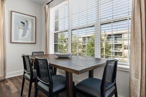 Atlanta apartment for rent - A dining room with a wooden table and chairs.
