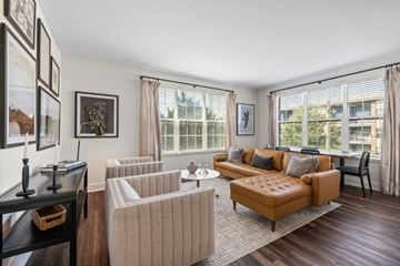 Atlanta apartment for rent - A living room with a brown sofa and a white chair.