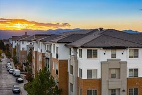 Denver apartment for rent - A sunset view of a street lined with apartment buildings.