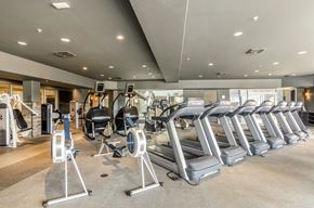 Superior apartment for rent - A gym with treadmills and exercise machines.