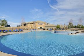 Superior apartment for rent - A large swimming pool with a building in the background.