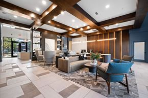 Plano apartment for rent - A spacious lobby with a variety of seating options and a marble floor.