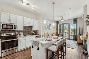 Raleigh apartment for rent - an open kitchen and dining area with a table and chairs