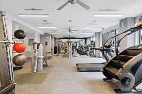 Dallas apartment for rent - a gym with treadmills and other exercise equipment in a building with glass walls