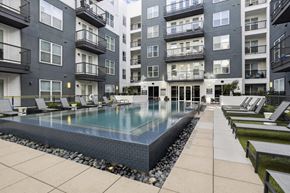 Dallas apartment for rent - a swimming pool in front of an apartment building