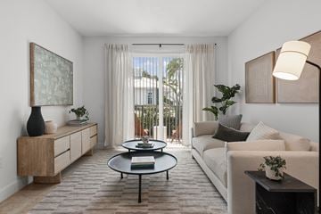 Miami apartment for rent - A living room with a white couch, a coffee table, and a painting on the wall.