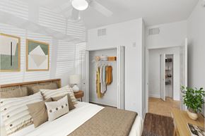 Miami apartment for rent - A bedroom with a bed, a ceiling fan, and a wardrobe.