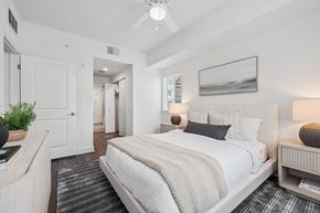 Miami apartment for rent - A bedroom with a large bed and a ceiling fan.