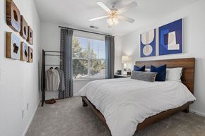 Mooresville apartment for rent - A bedroom with a large bed and a ceiling fan.