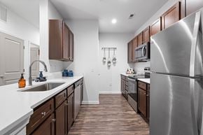 Mooresville apartment for rent - A modern kitchen with wooden cabinets and stainless steel appliances.
