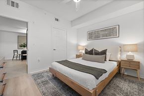 Miramar apartment for rent - A bedroom with a large bed and a painting on the wall.